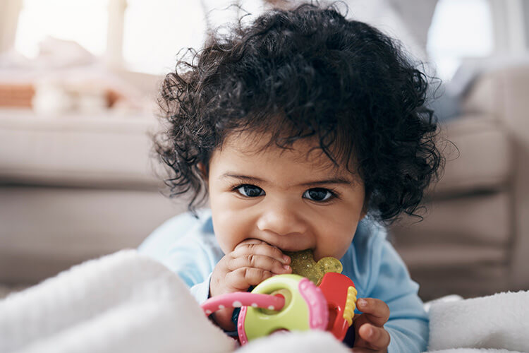 Baby teething on toy